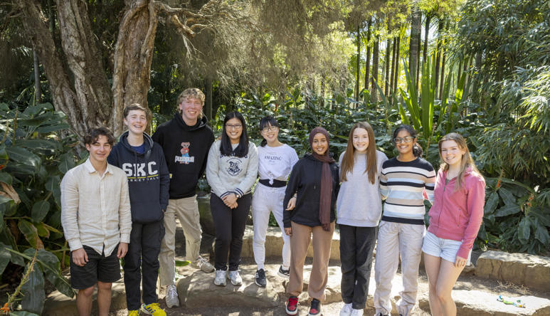 The nine then-active members of ZV's Youth Advisory Committee, rowed up in the Rainforest and smiling to the camera.