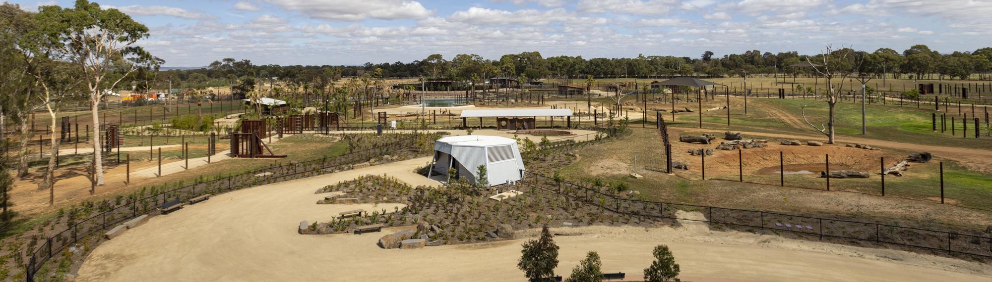 A view of the new Elephant Trail, towards the Elephant Café, beneath an overcast sky.