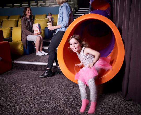 A girl sliding down at Vjunior slides