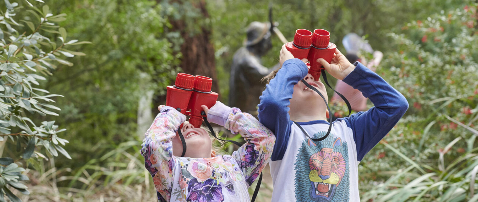 Two Kinder Kids Look Through Binoculars