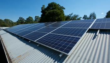 Solar panels on the roof of a building with a blue sky background