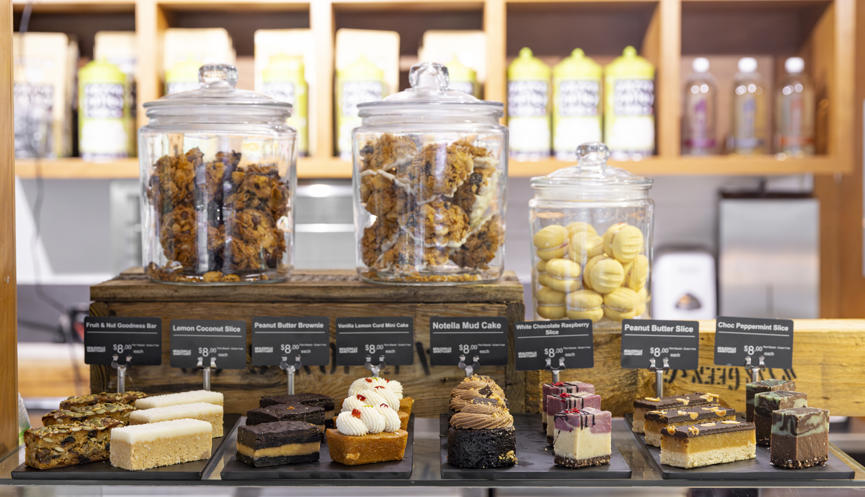 Jars of muffins, cookies and dessert slices on a benchtop in the Sanctuary Harvest Cafe.